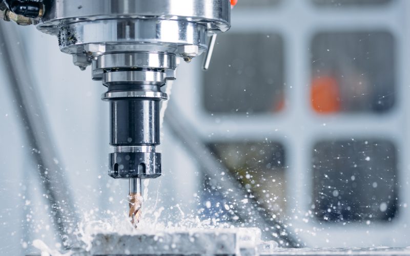 Working closeup CNC turning cutting metal Industry machine iron tools with splash water.